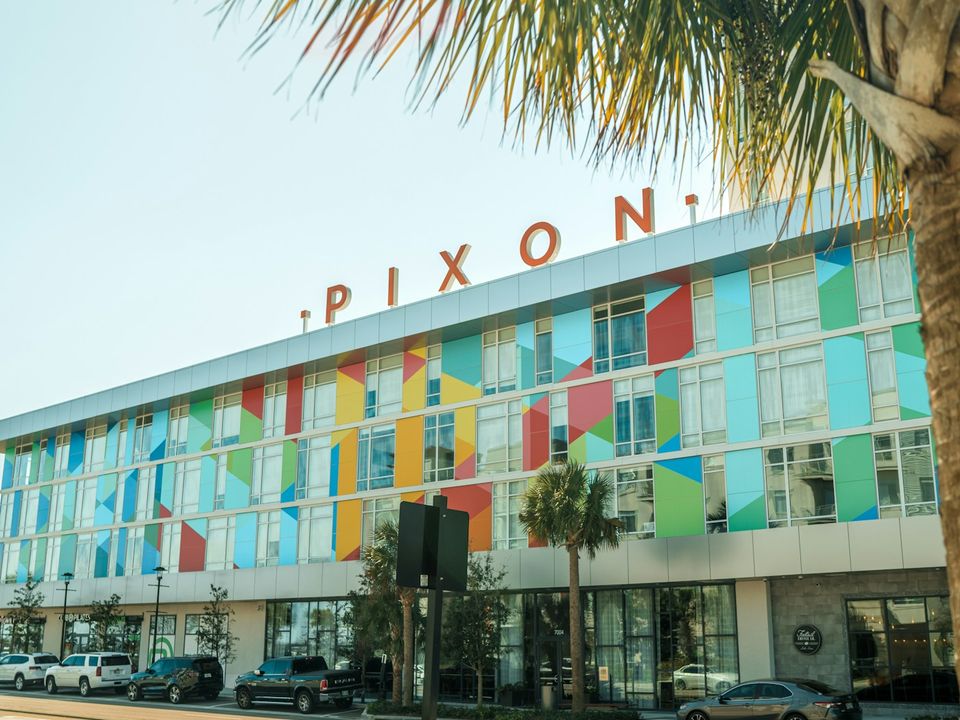 A colorful modern building with palm trees in Lake Nona, Orlando