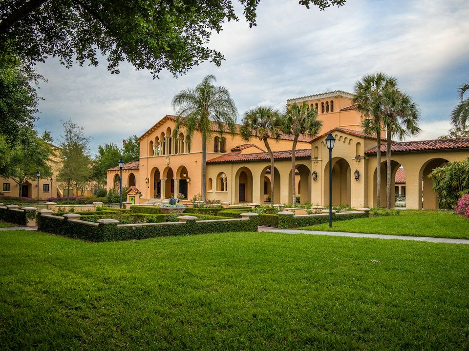 A Mediterranean-style courtyard framed by palm trees in Winter Park, Florida